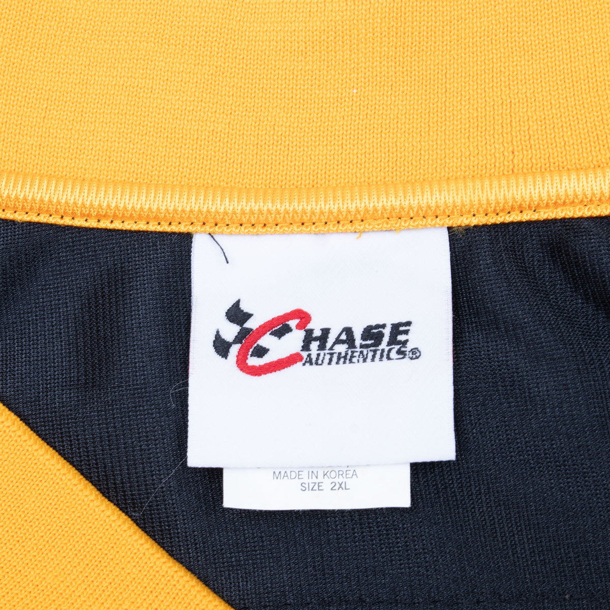 Close-up of Chase Authentics neck label and size 2XL tag inside Dale Jarrett jersey