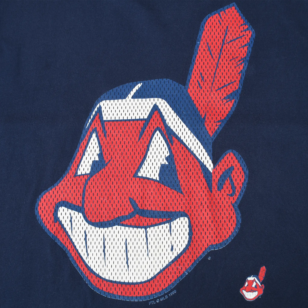Close-up of red, white, and blue Chief Wahoo front graphic on navy T-shirt