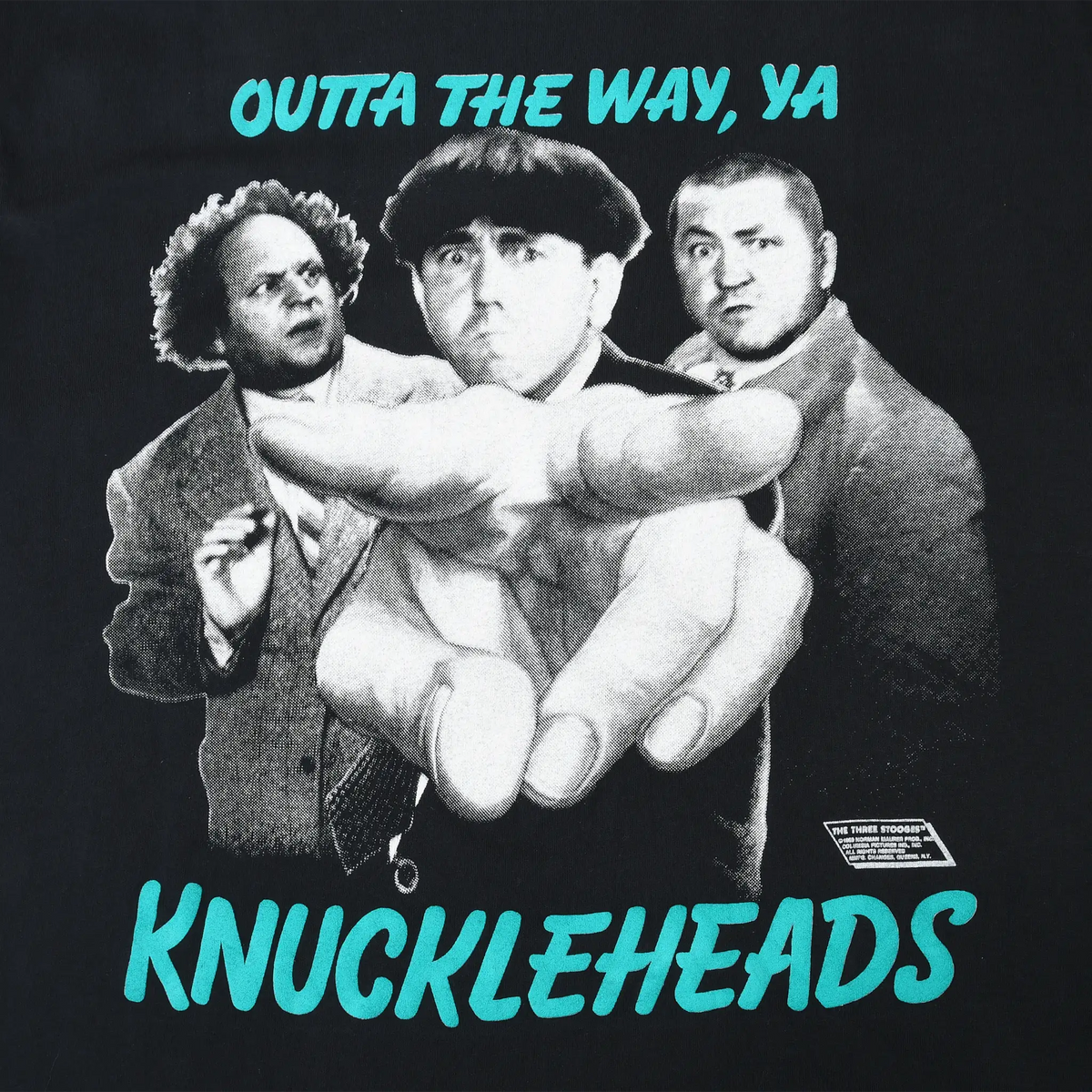 Close-up of Three Stooges print with grayscale portraits, pointing hand and turquoise text