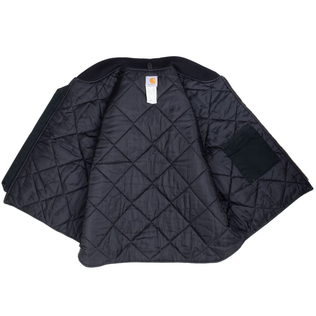 Open Carhartt vest showing black diamond-quilted lining, neck label, and interior pocket