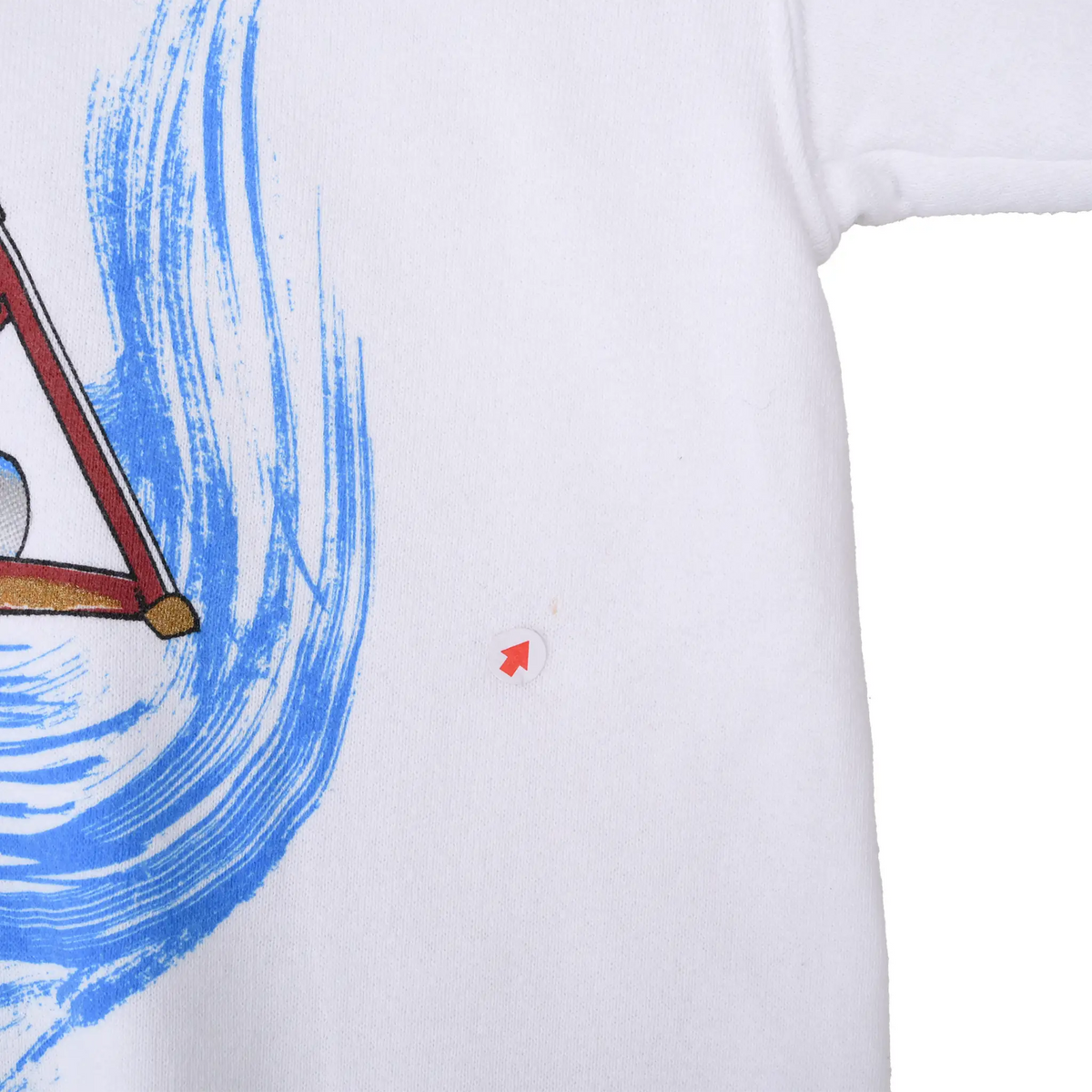 Close-up of small reddish mark beside the blue water print on white sweatshirt fabric