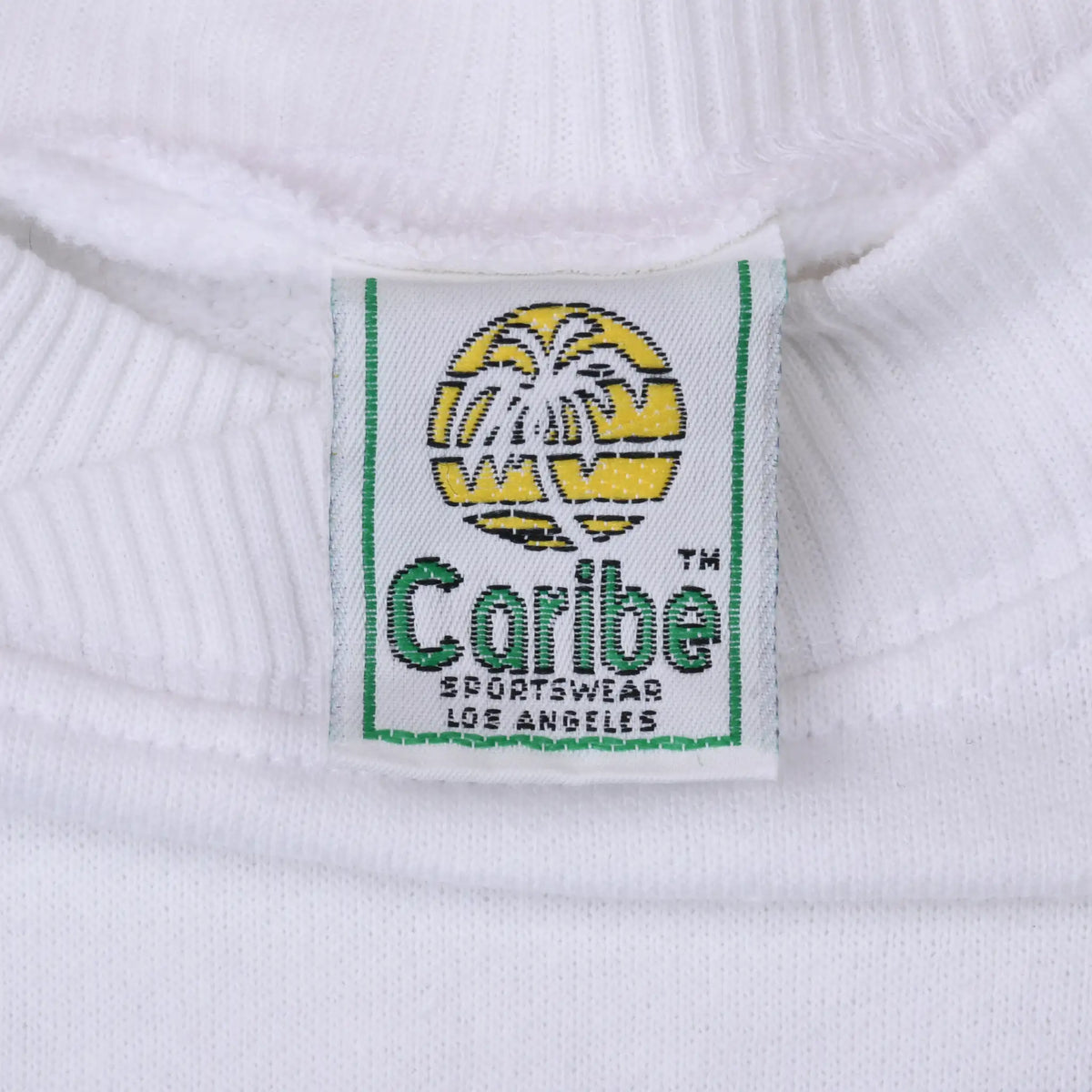 Close-up of Caribe Sportswear Los Angeles neck label inside white sweatshirt