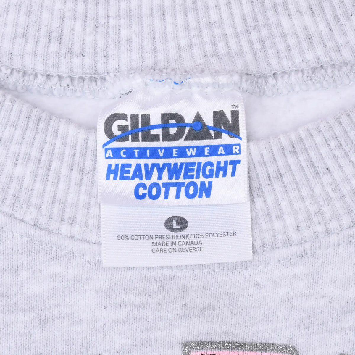 Close-up of Gildan Activewear Heavyweight Cotton neck tag inside gray sweatshirt