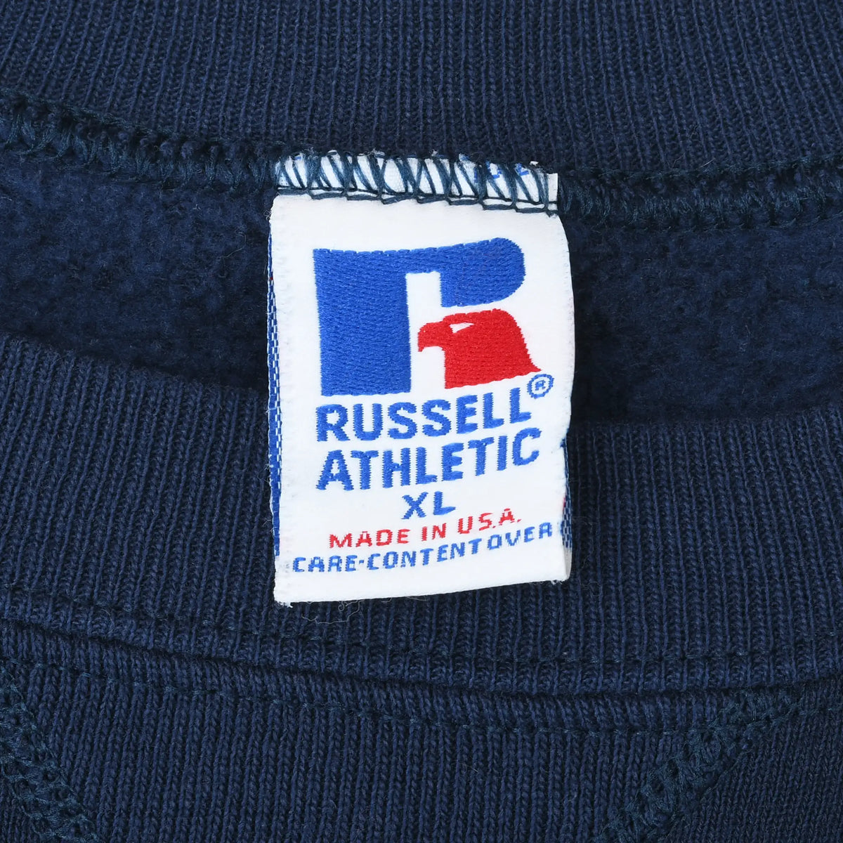 Russell Athletic XL neck tag on navy sweatshirt, marked Made in USA