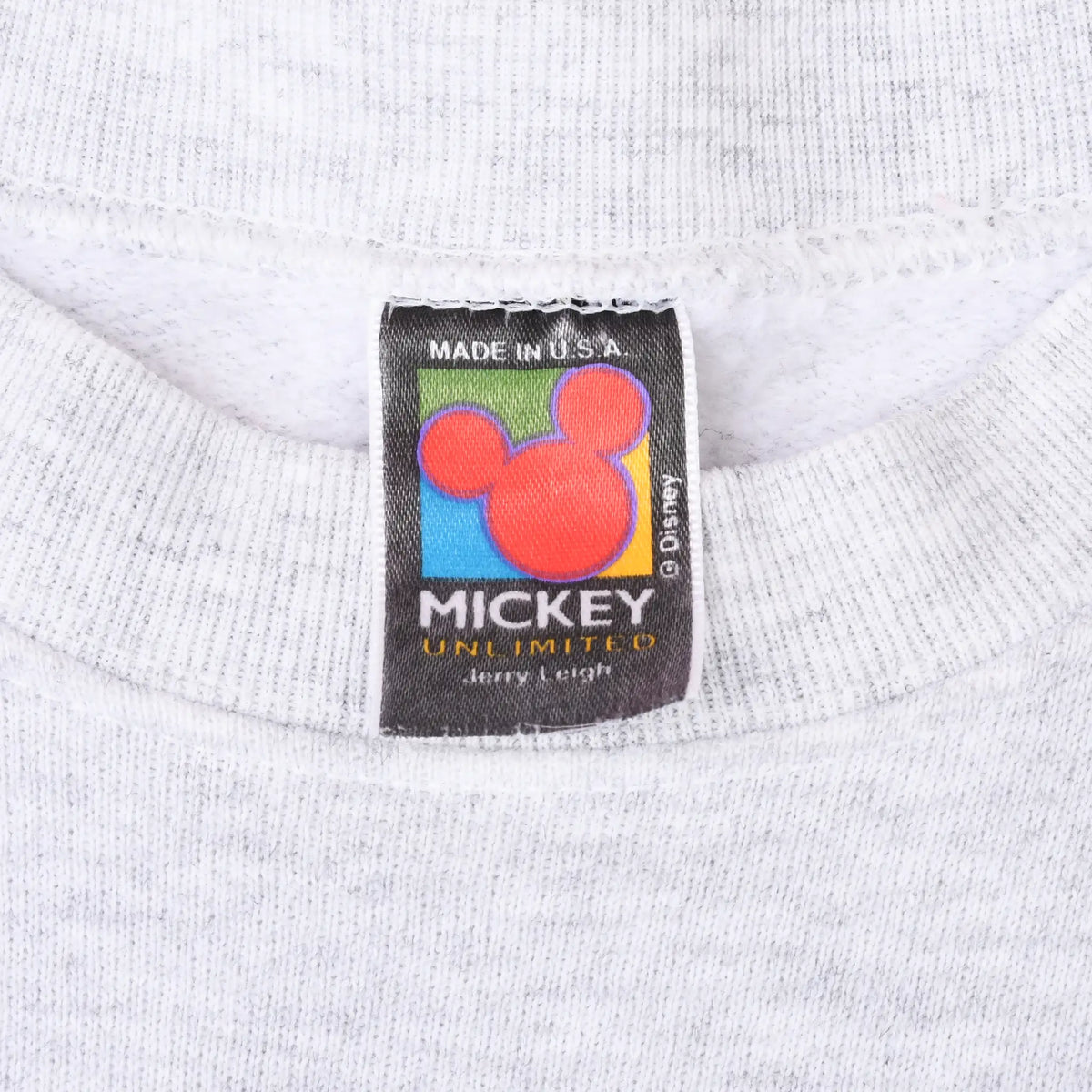 Close-up of Mickey Unlimited neck label on grey sweatshirt