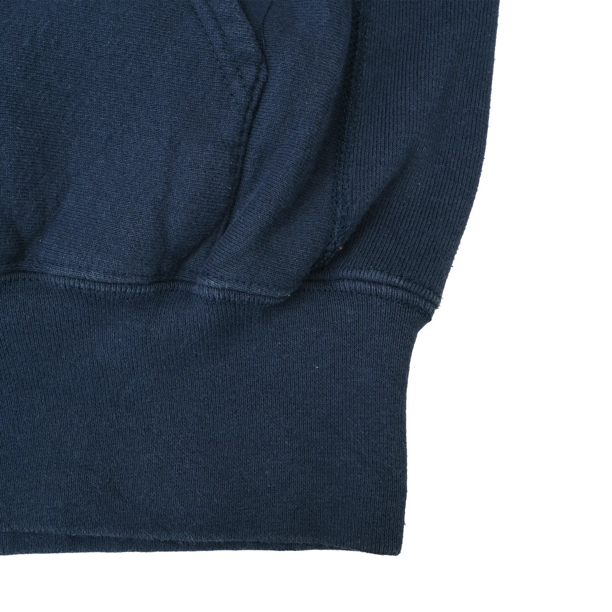 Close-up of navy hoodie waistband, pocket seam, and sleeve cuff