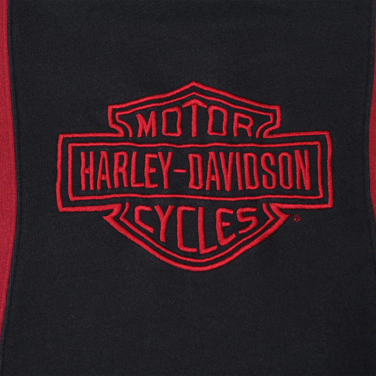 Close-up of red Harley-Davidson Motor Cycles shield embroidery on black chest