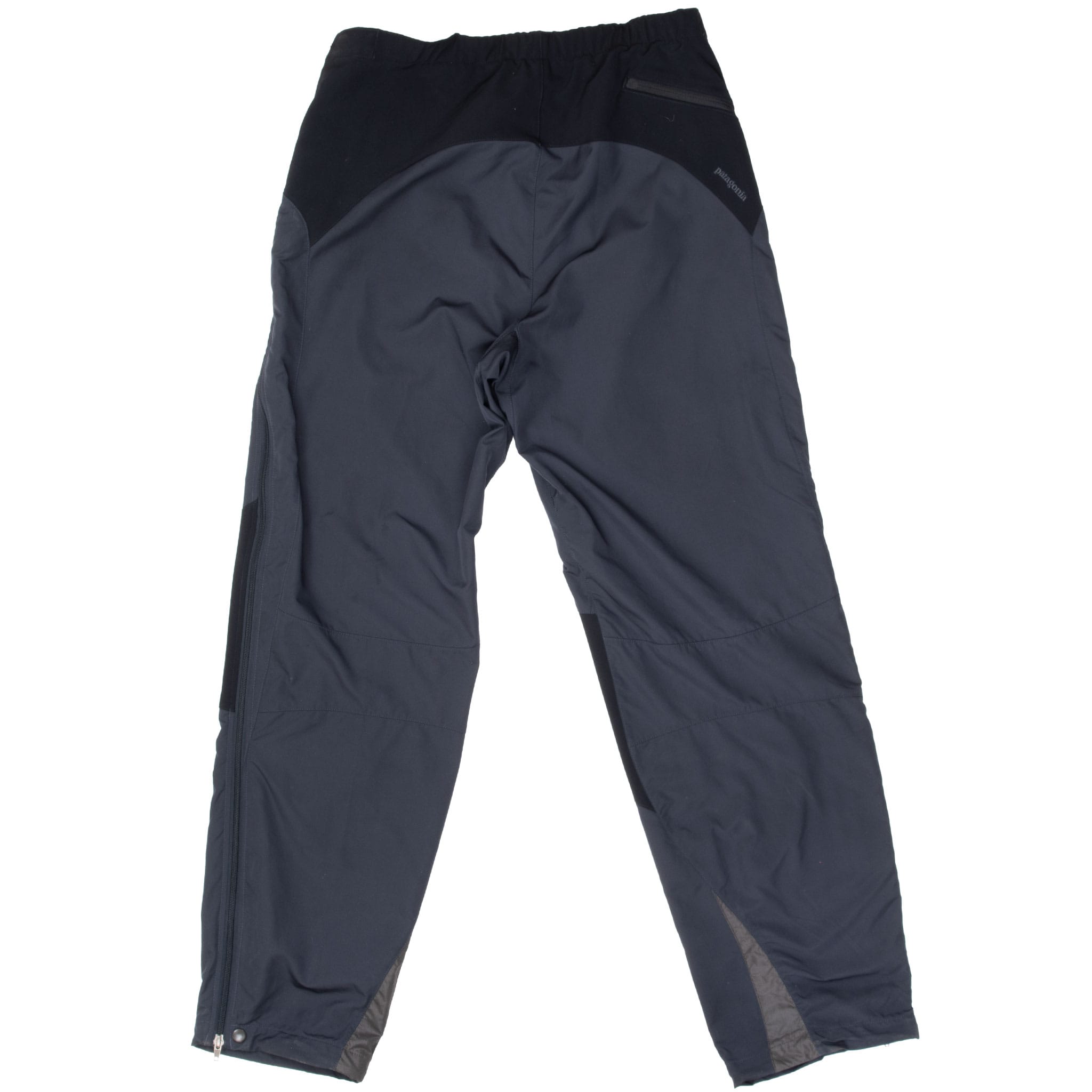 Back of black Patagonia Integral pants with rear waist panel, zip pocket, and cuff snaps