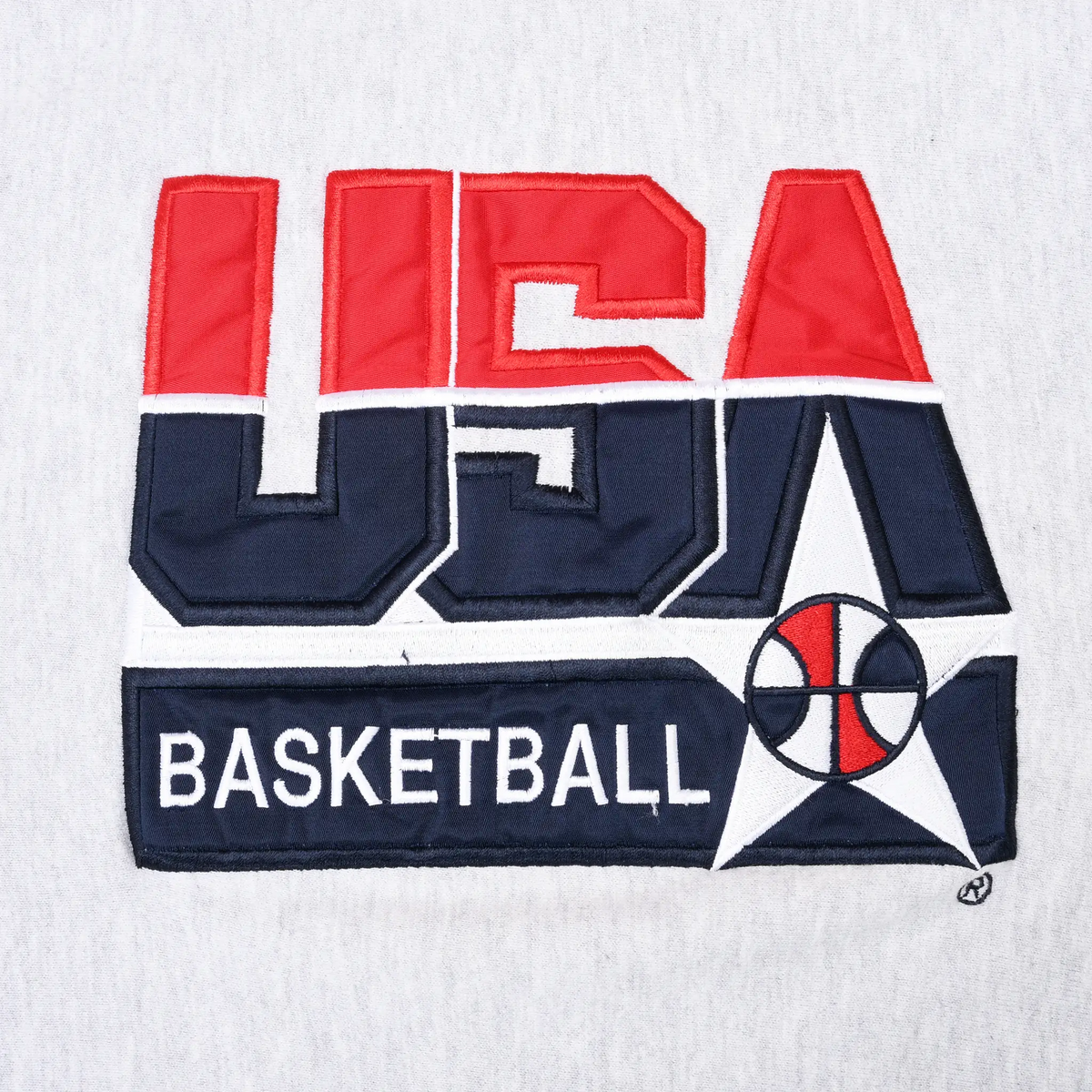 Close-up of red, navy, and white USA Basketball chest graphic