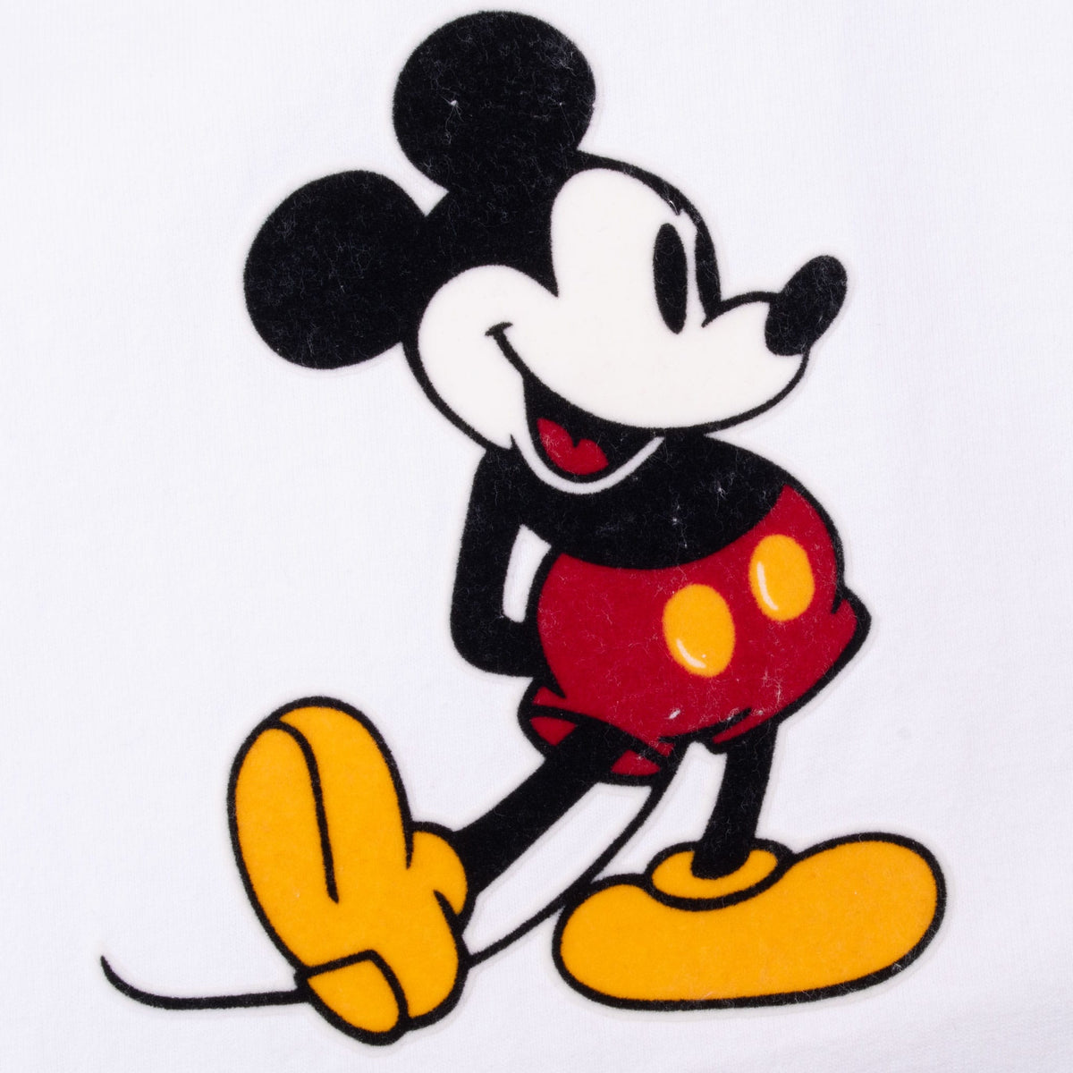 Close-up of Mickey Mouse chest graphic in black, red, yellow and white