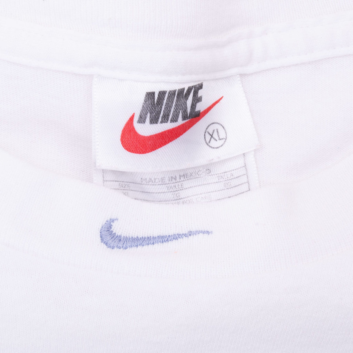 Nike XL neck tag and light blue embroidered Swoosh at the center neckline