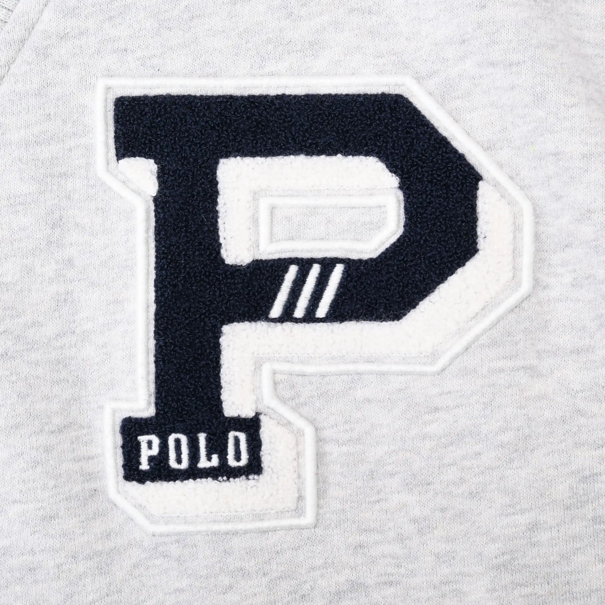 Close-up of navy and white chenille P varsity patch with Polo lettering