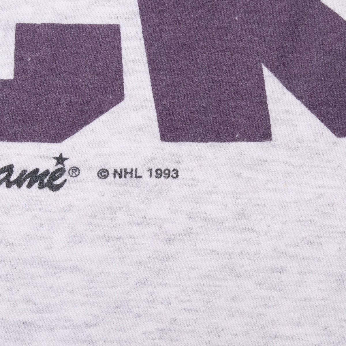 Close-up of The Game branding and NHL 1993 copyright mark below front print