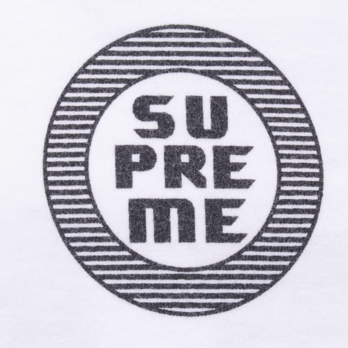 Close-up of small black striped Supreme Disrupt Circle chest print