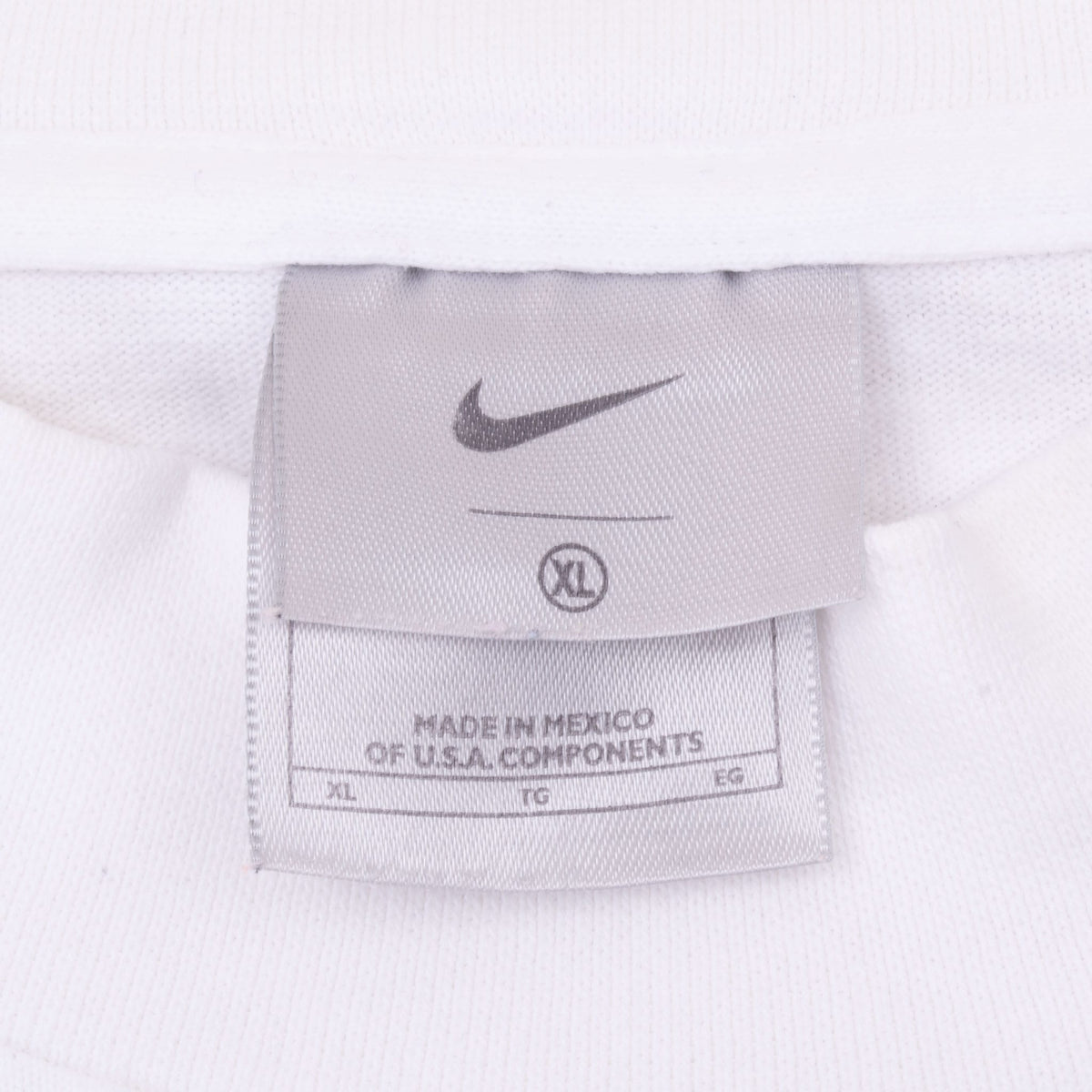 Close-up of Nike neck tag with Swoosh logo and XL size marking