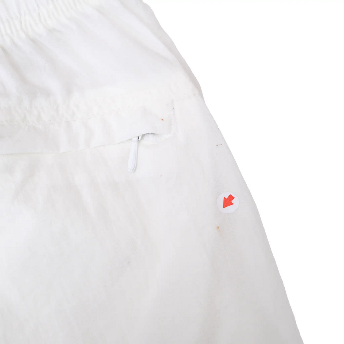 Close-up of back pocket area with small marks indicated beside the zipper