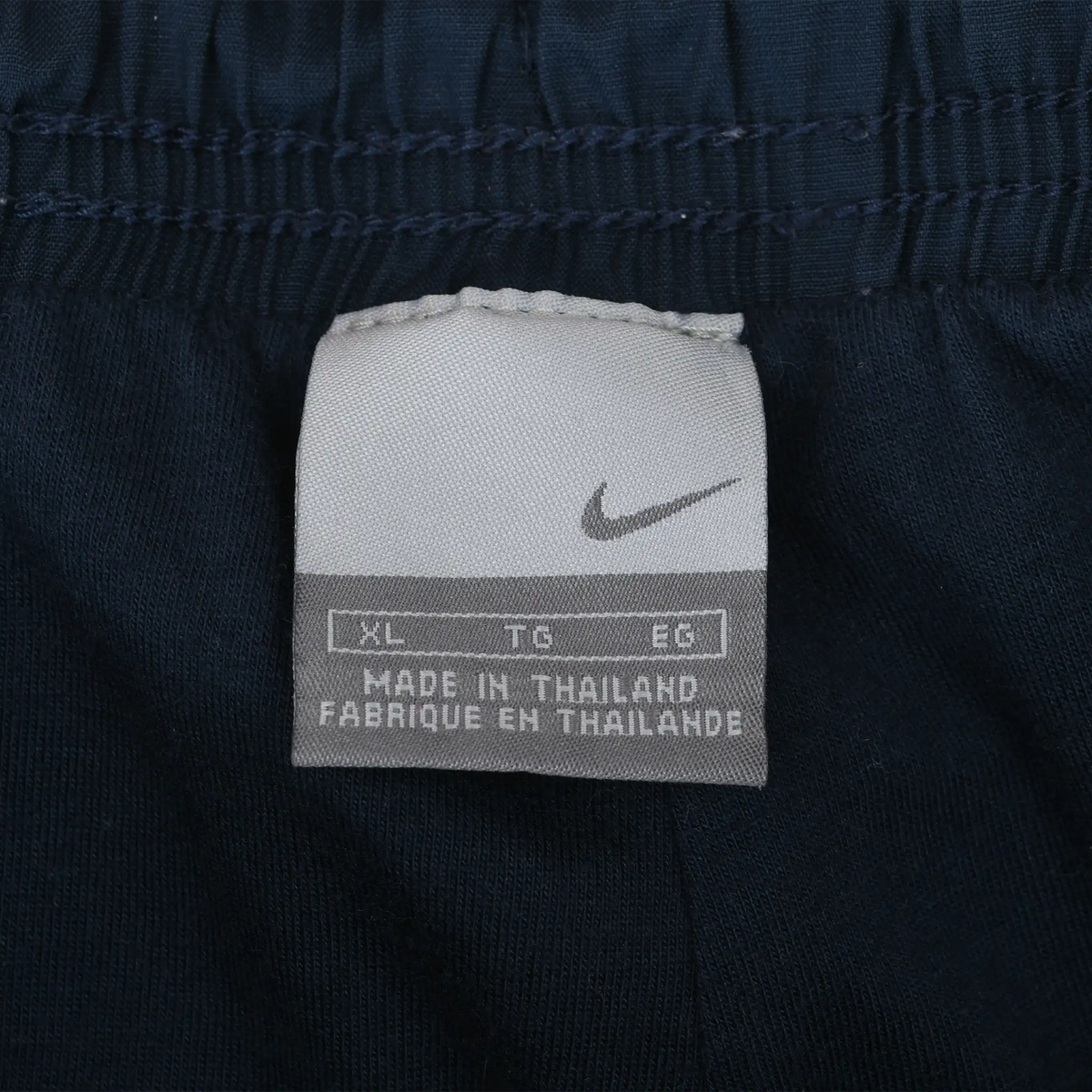 Nike waistband tag showing Swoosh, XL sizing, and Made in Thailand text