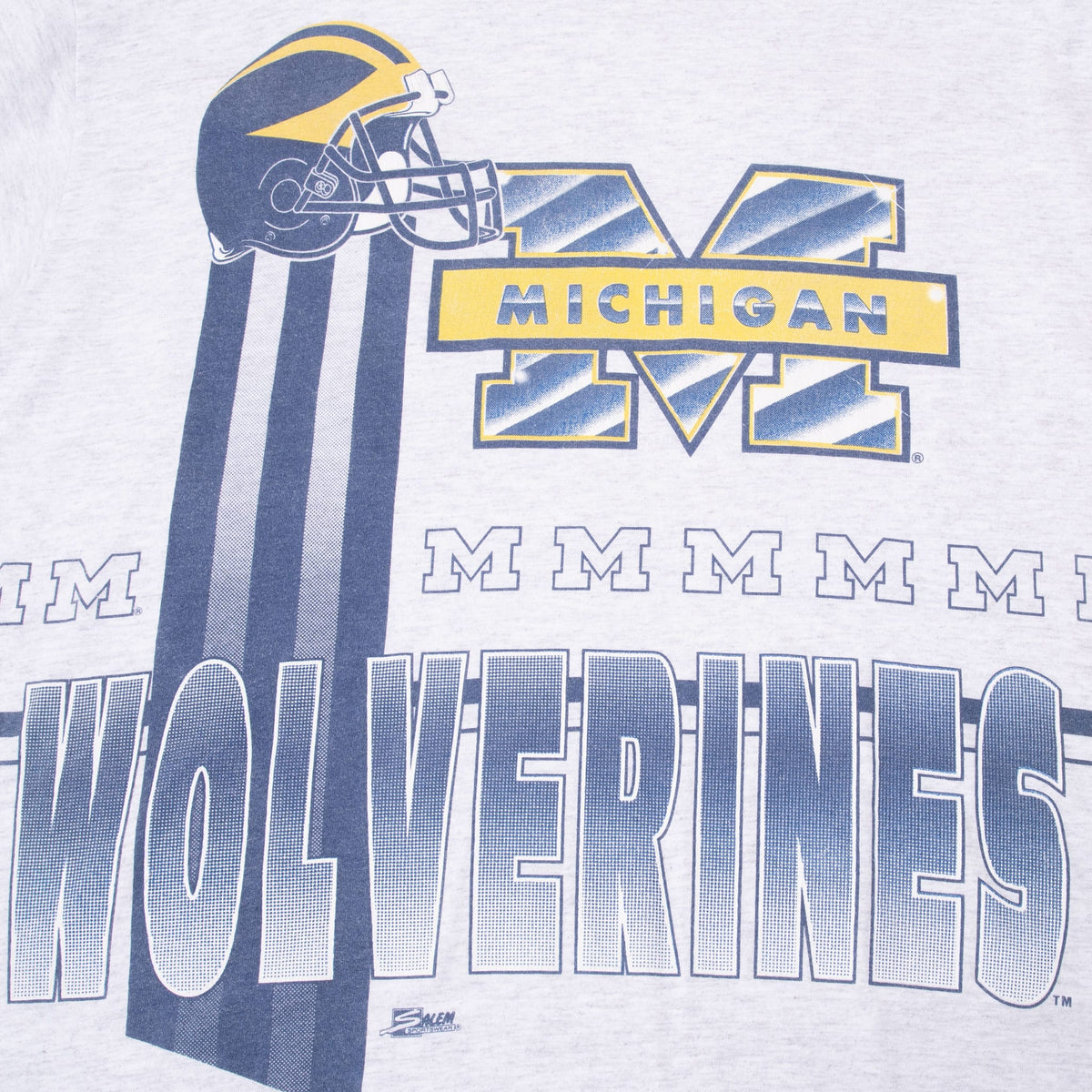 Close-up of front Michigan Wolverines print with football helmet, block M and vertical blue stripes