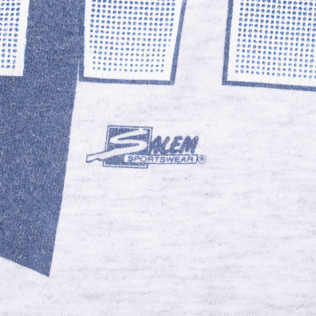 Close-up of Salem Sportswear logo printed below the Wolverines graphic