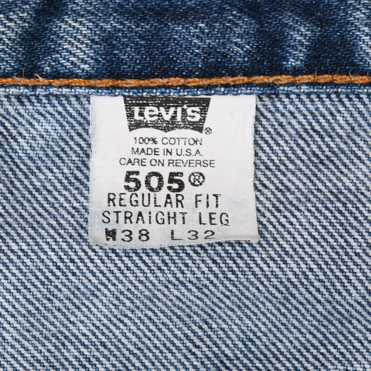Levi's 505 interior tag marked regular fit, straight leg, W38 L32, 100% cotton, and Made in USA