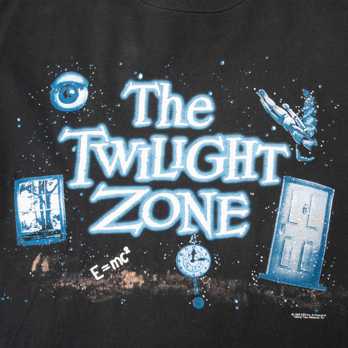 Close-up of blue-and-white The Twilight Zone graphic with eye, doors, falling figure and clock