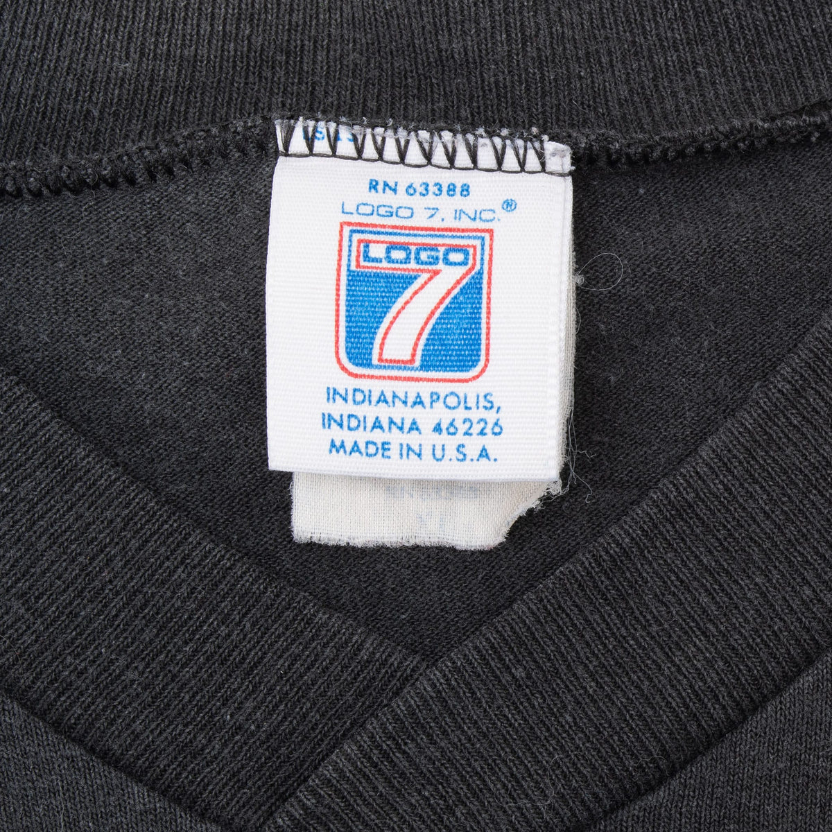 Logo 7 neck tag on black Pittsburgh Steelers V-neck T-shirt showing Made in U.S.A.