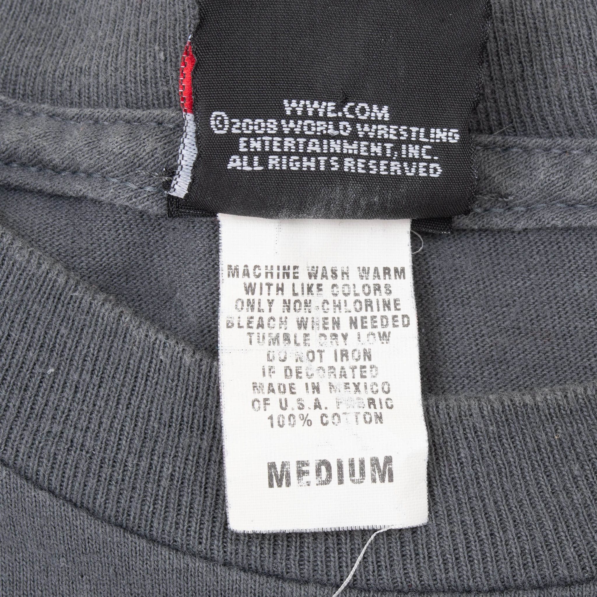 WWE copyright and care label showing medium and 100% cotton