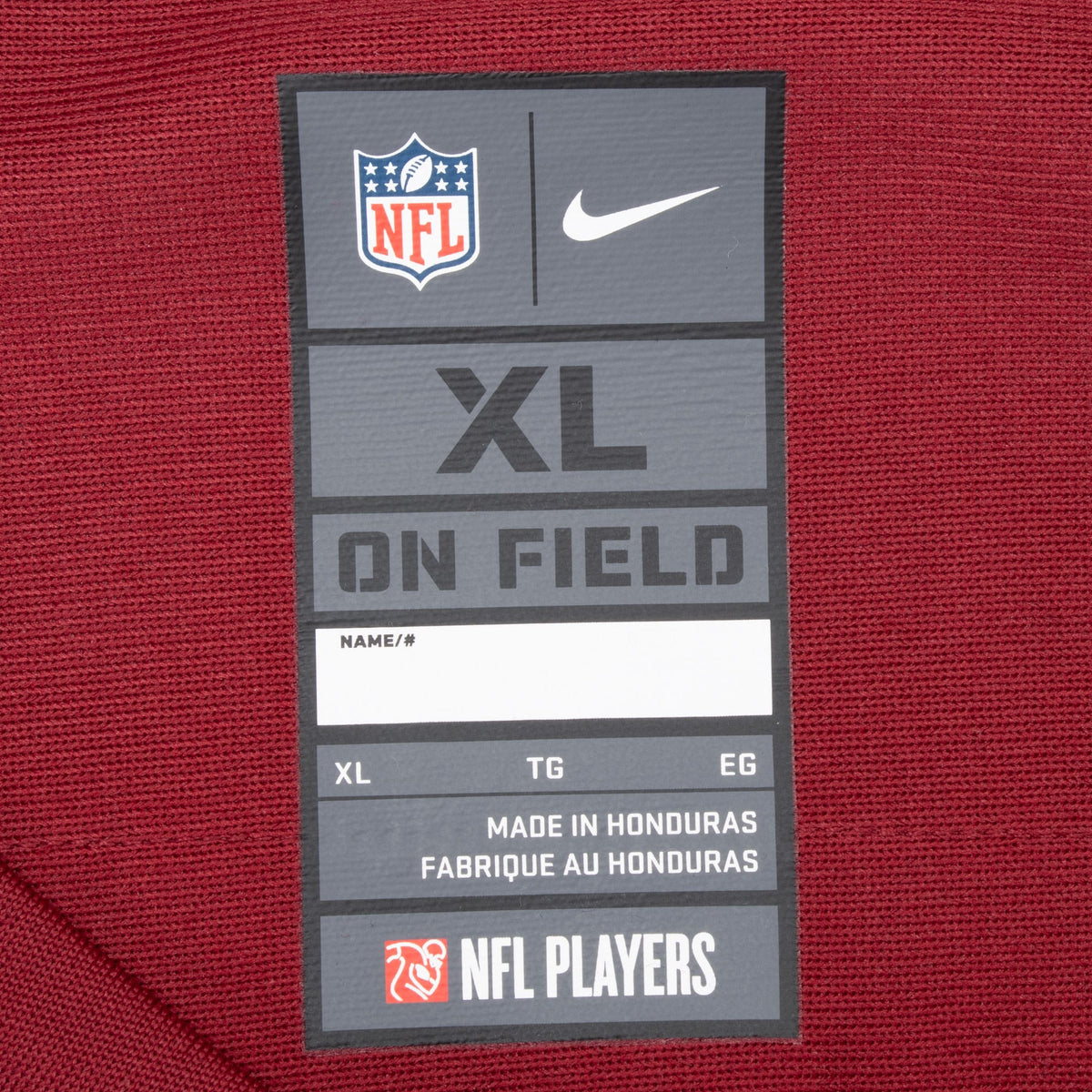Inside Nike NFL On Field neck label marked XL on burgundy jersey fabric