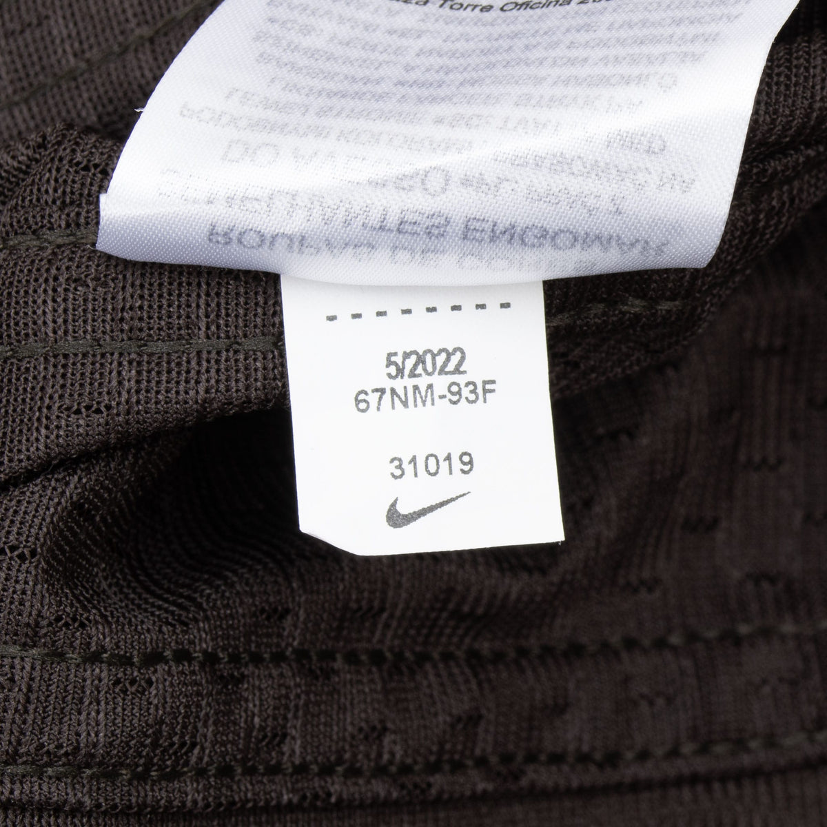 Close-up of interior care tag with Nike Swoosh and printed codes