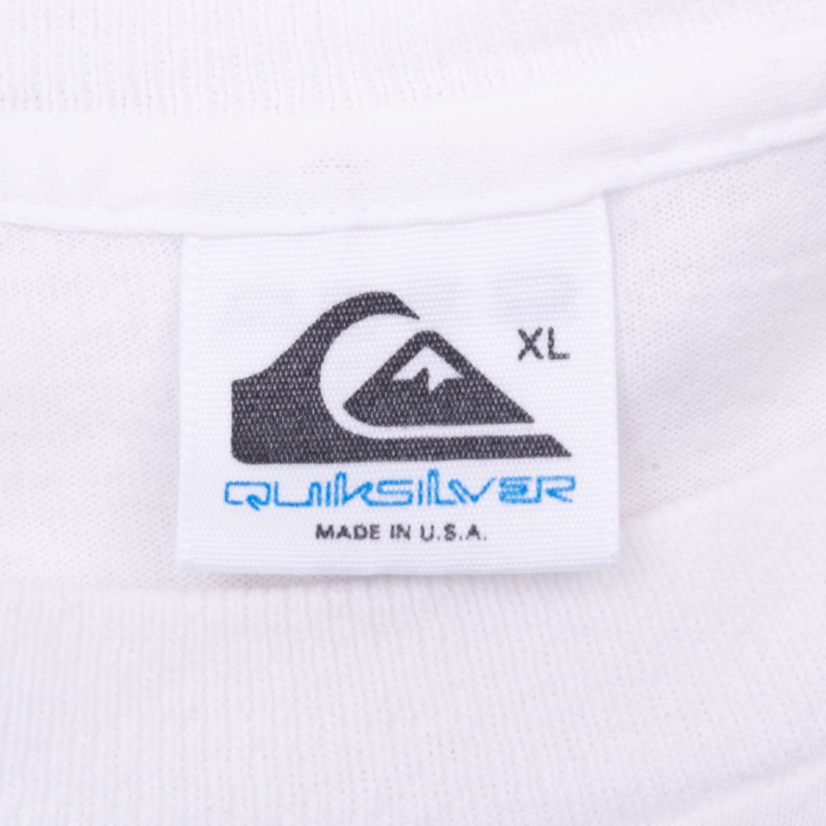 Quiksilver neck tag marked XL and Made in U.S.A. on white T-shirt