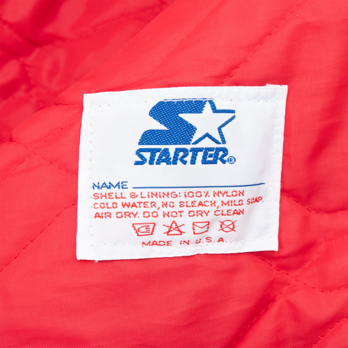 Starter care label with logo and Made in U.S.A. text on red quilted lining