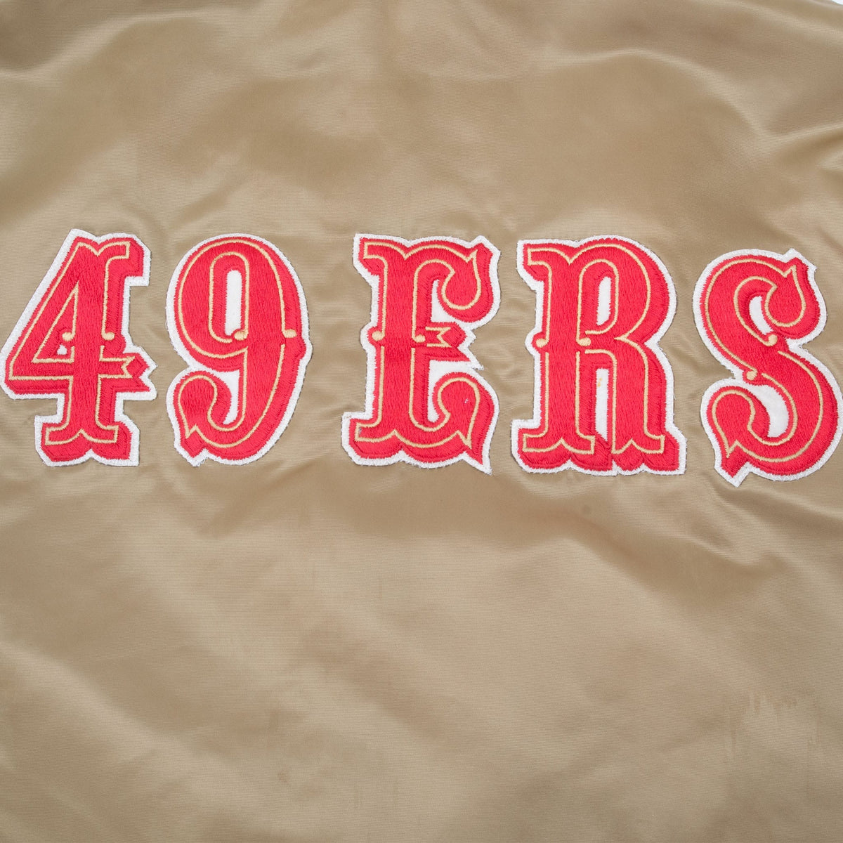 Close-up of large red and white 49ERS lettering embroidered across the jacket back