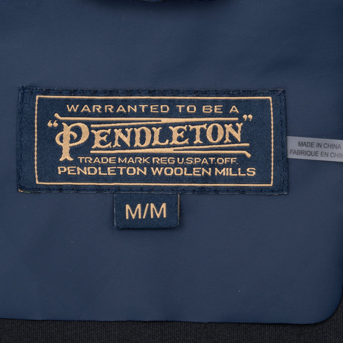 Pendleton neck label and medium size tag inside navy rain jacket