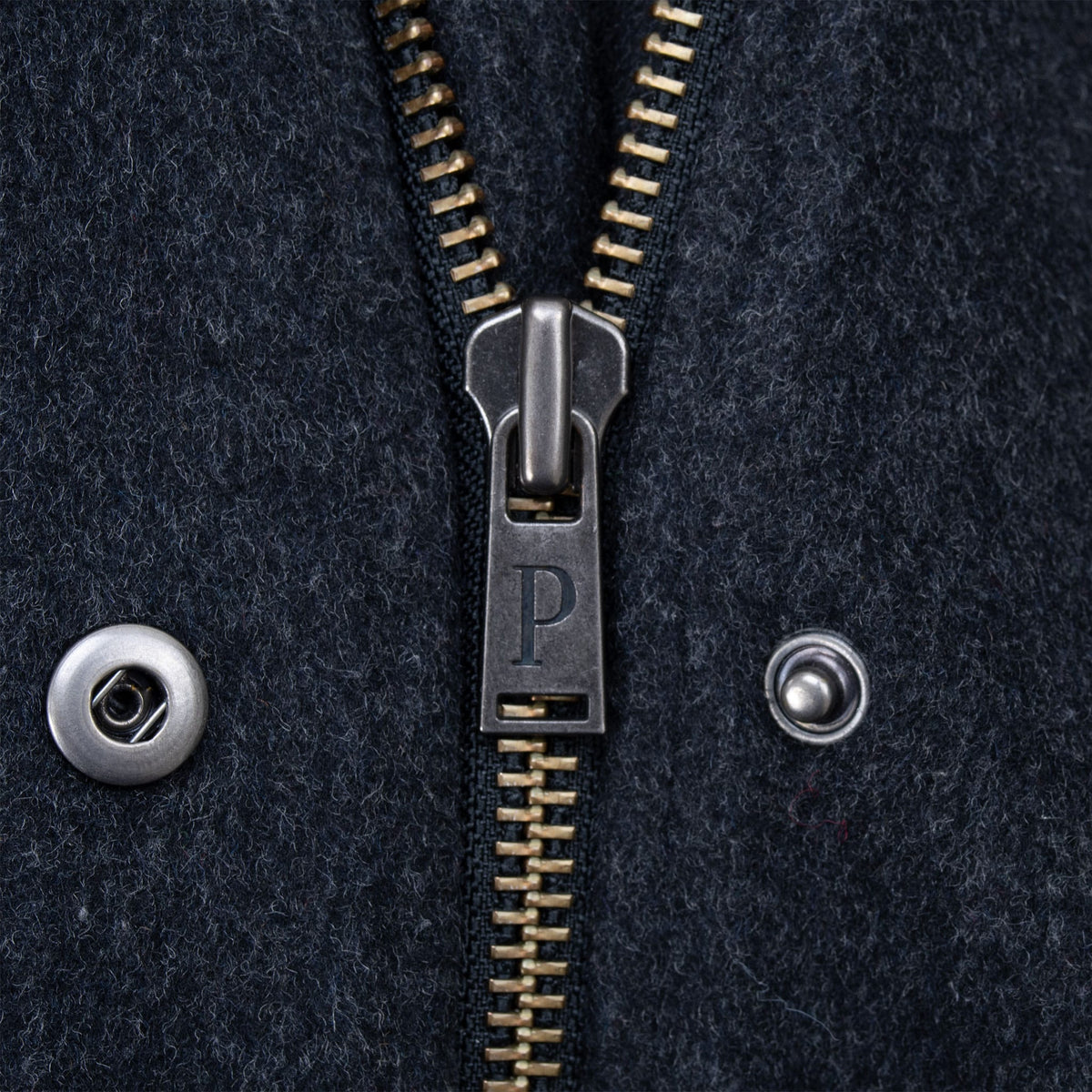 Close-up of Pendleton coat zipper with P pull and metal snap closure