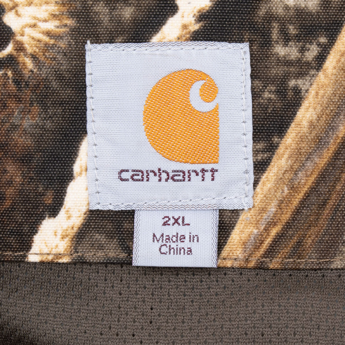 Carhartt neck label and 2XL size tag inside camouflage parka