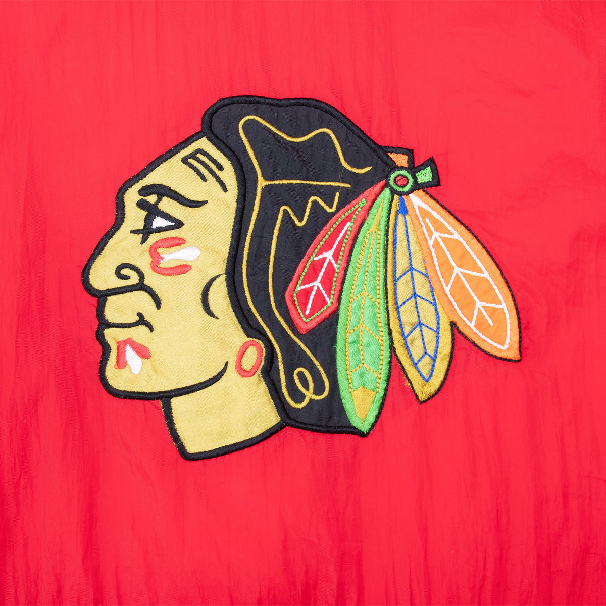 Large Chicago Blackhawks logo embroidery on back of red jacket