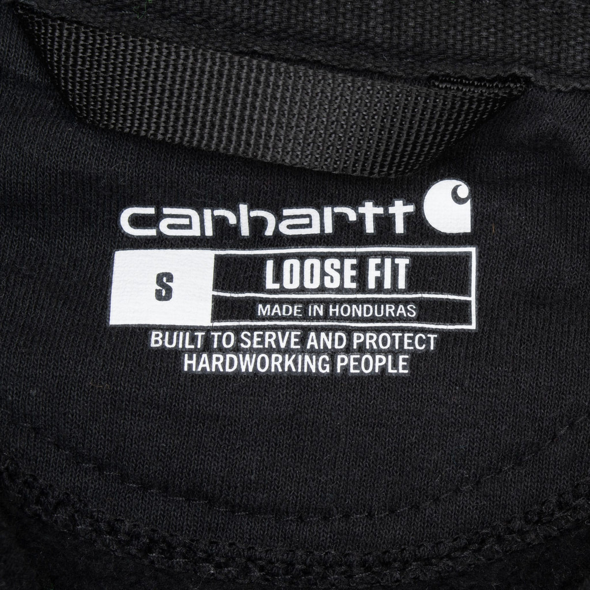 Carhartt printed neck label showing loose fit and size small