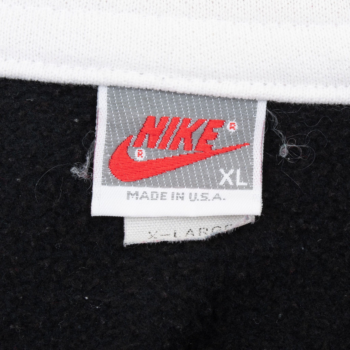Nike neck label showing Swoosh logo, size XL and Made in U.S.A.