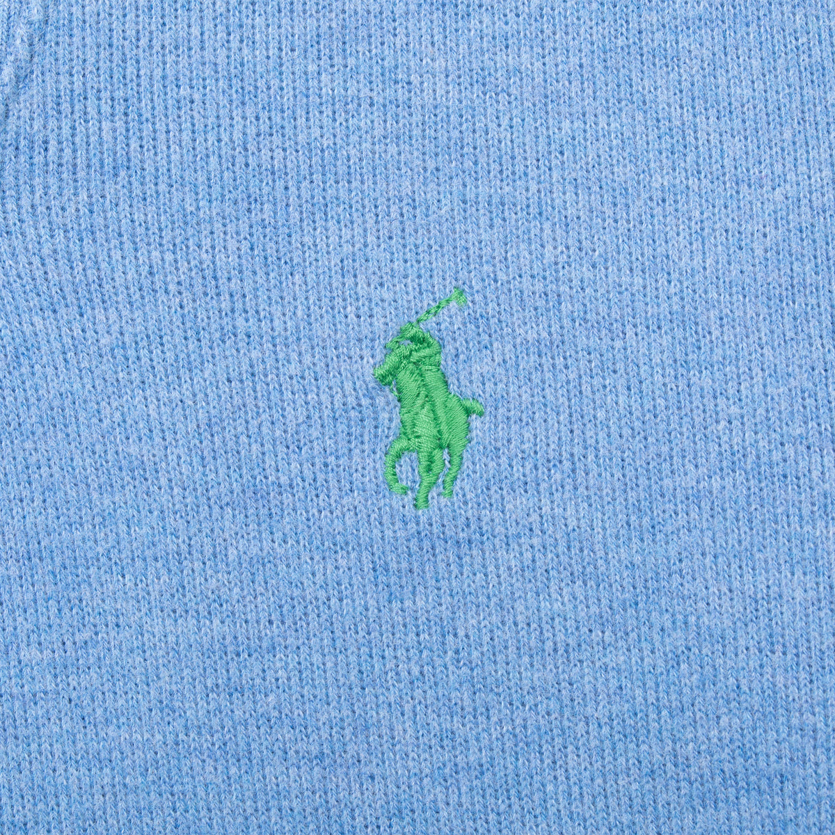Green Polo pony embroidery on blue sweater fabric