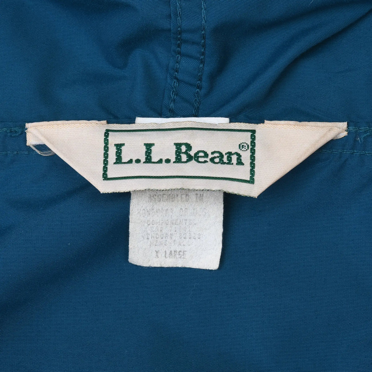 Close-up of woven L.L.Bean neck label inside the teal anorak