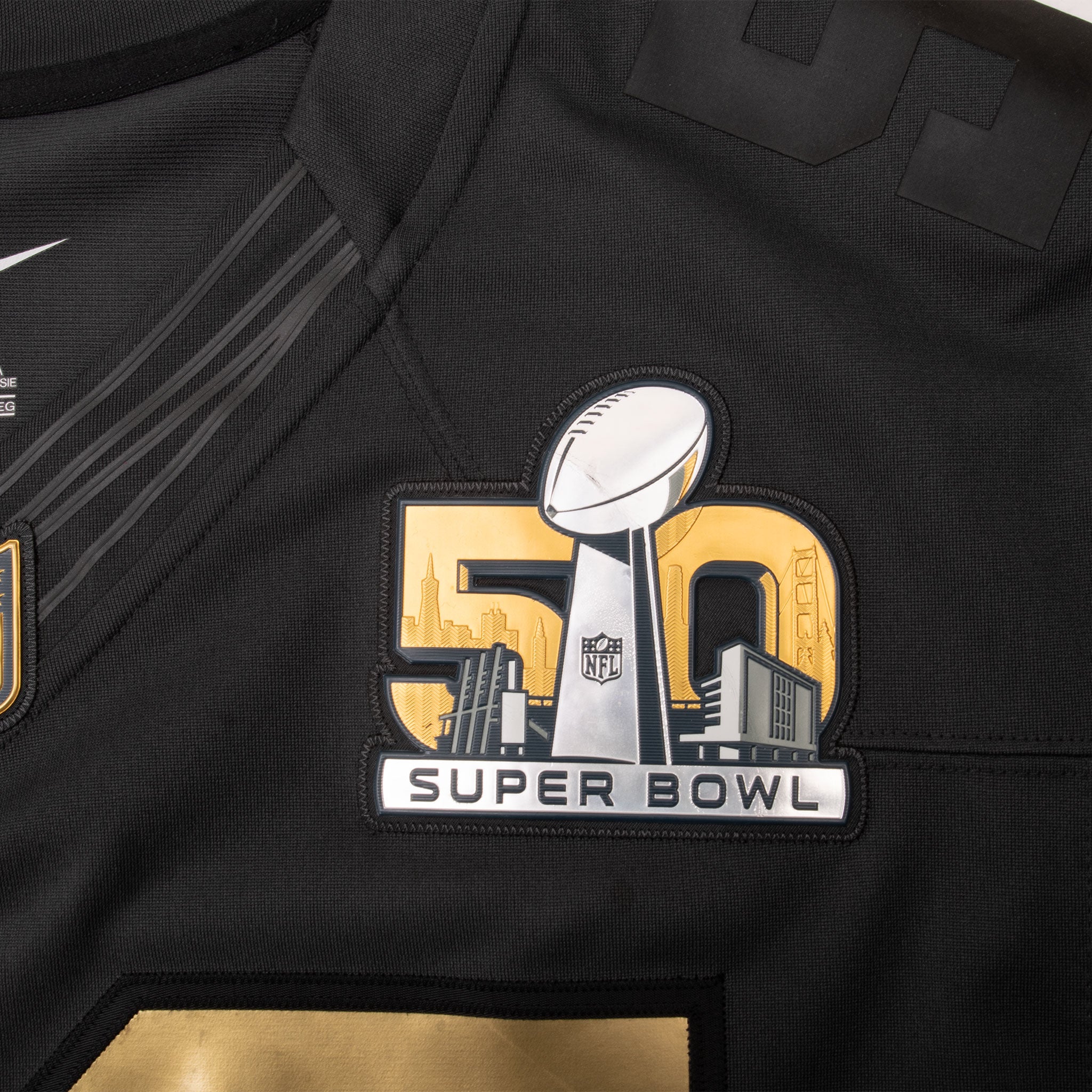 Close-up of gold, white and black Super Bowl 50 chest patch