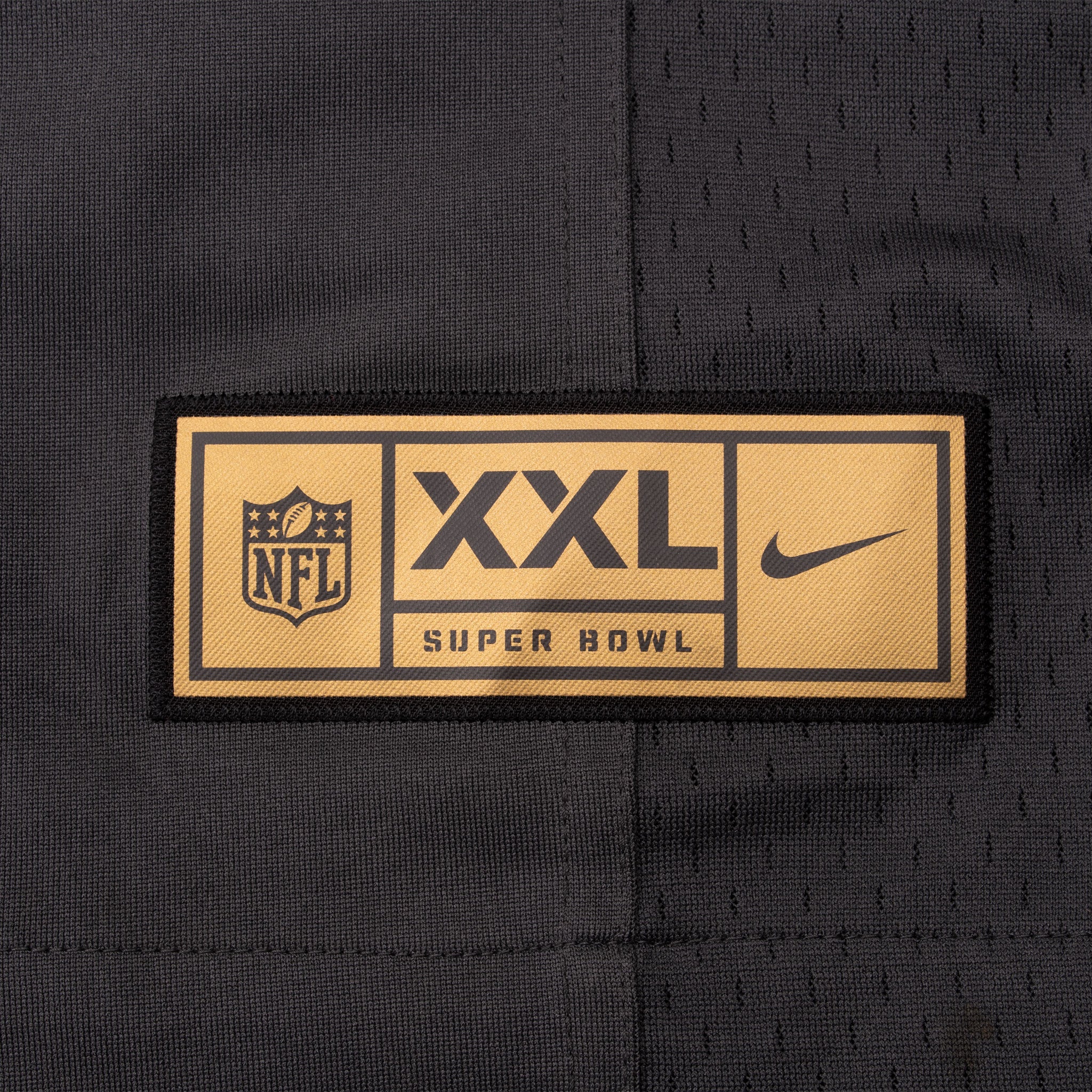 Gold NFL Nike Super Bowl hem label marked XXL on black jersey