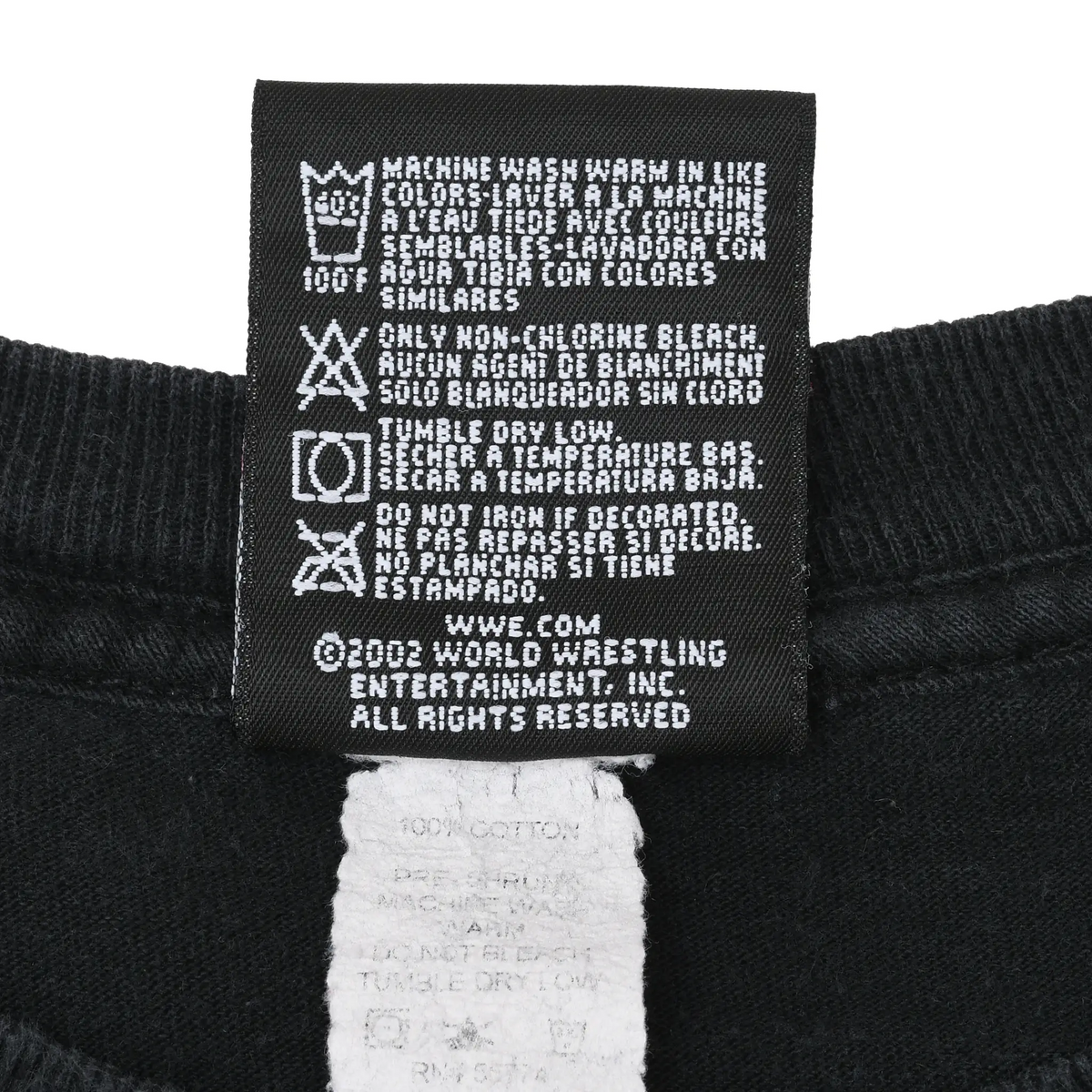 Close-up of black WWE garment care label with washing instructions and copyright text
