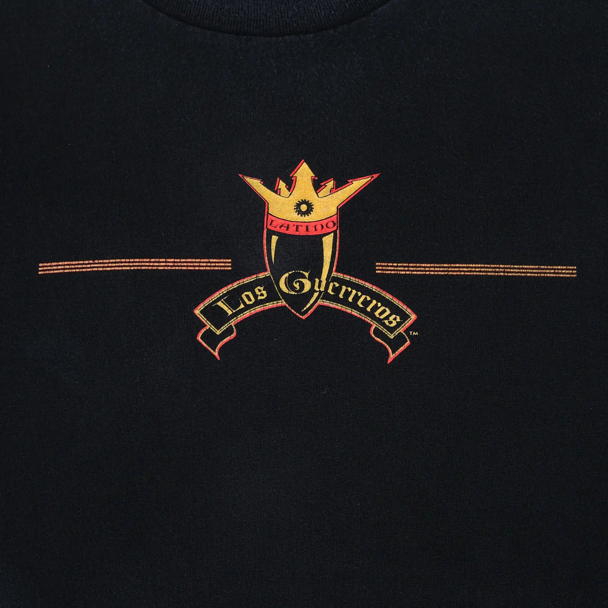 Close-up of gold and red Los Guerreros crown crest on the front