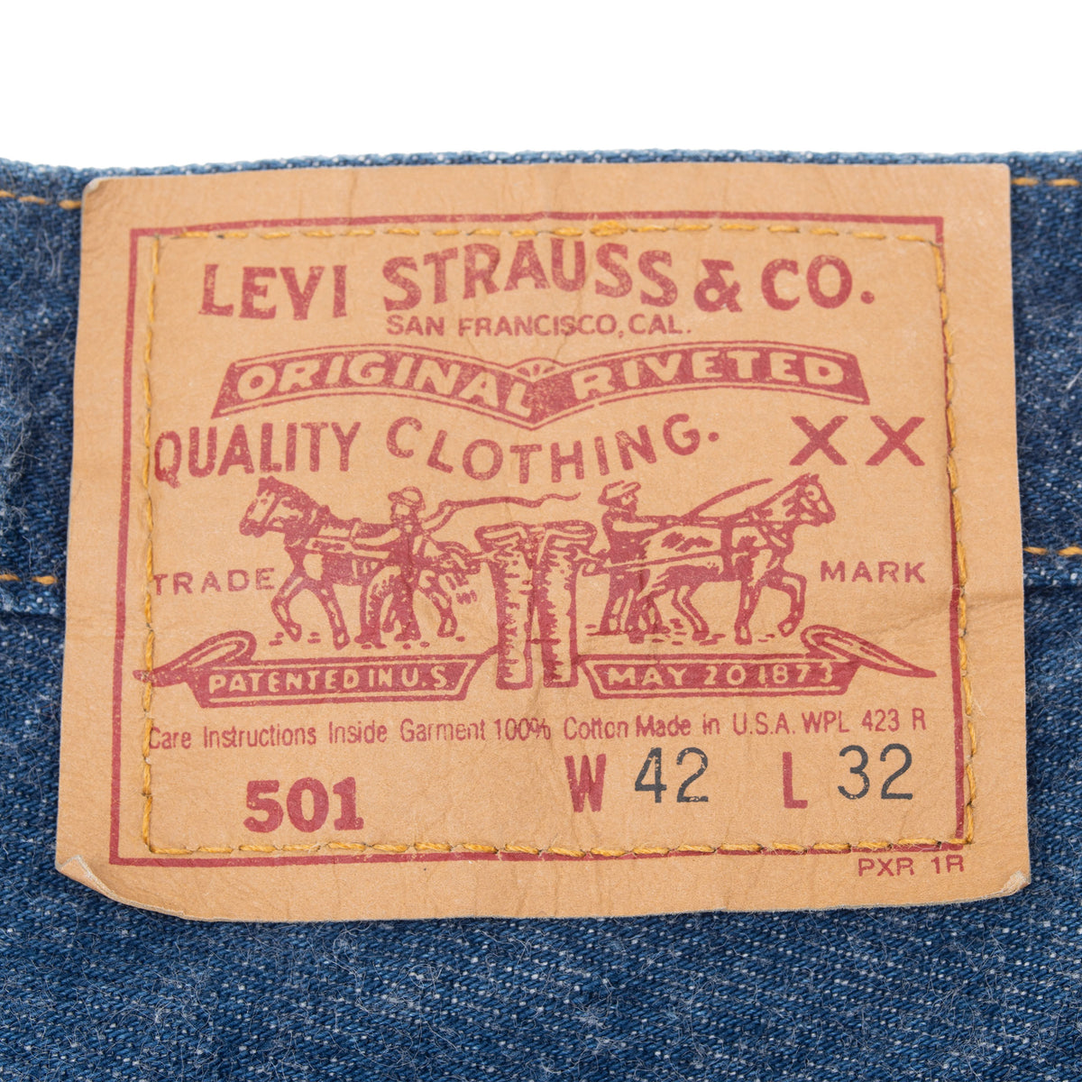 Levi Strauss & Co. 501 waist patch marked W42 L32 on indigo jeans