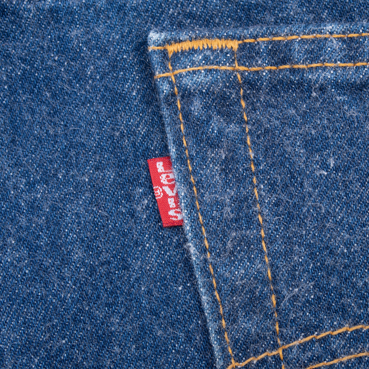 Close-up of red Levi's tab and orange stitching on back pocket