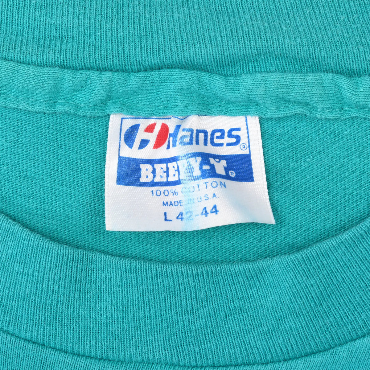 Close-up of Hanes Beefy-T neck label on teal T-shirt