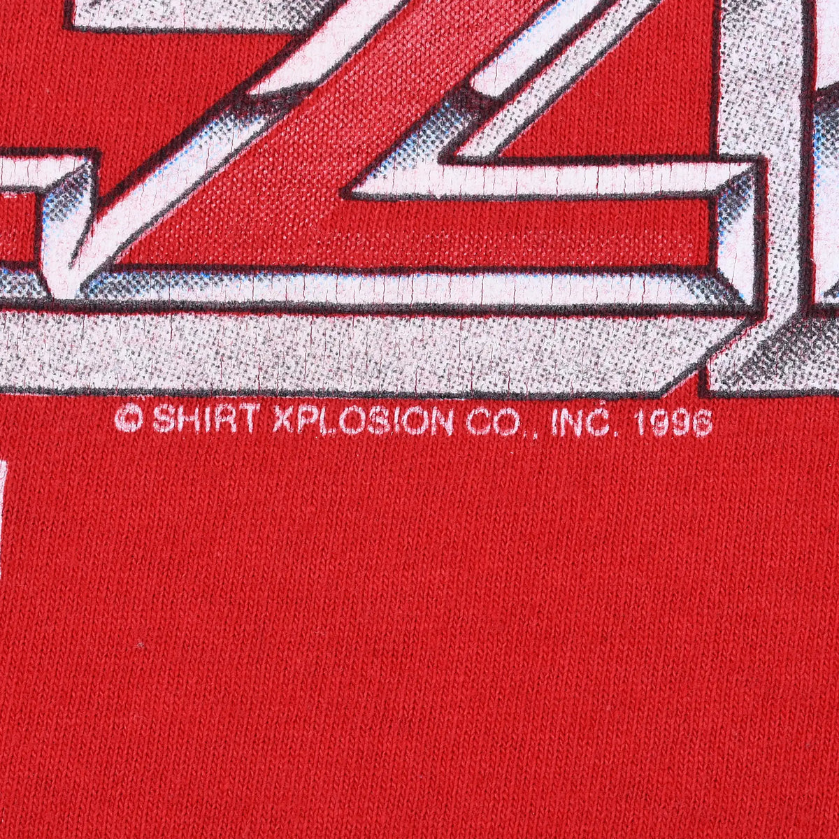 Close-up of Ozzie graphic copyright text reading Shirt Xplosion Co., Inc. 1996