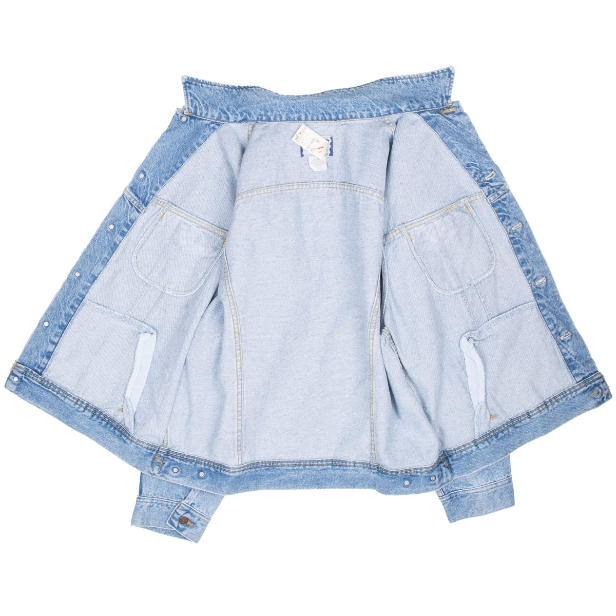 Open Lee blue denim trucker jacket showing unlined interior, seams and pocket bags