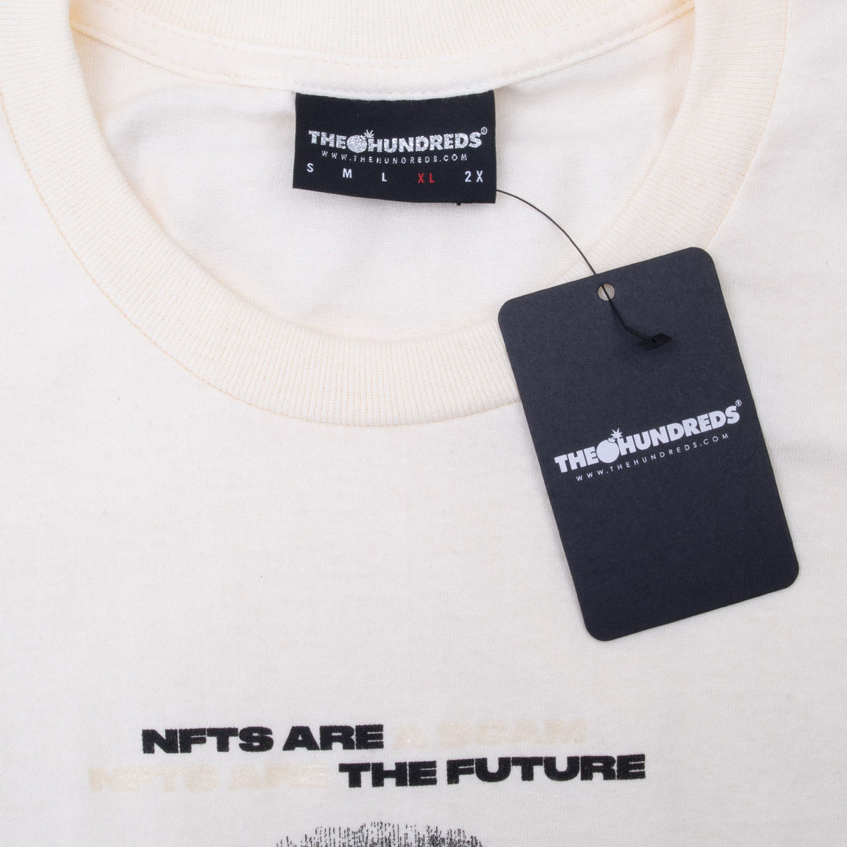 The Hundreds XL neck label and black hangtag on ivory crewneck T-shirt